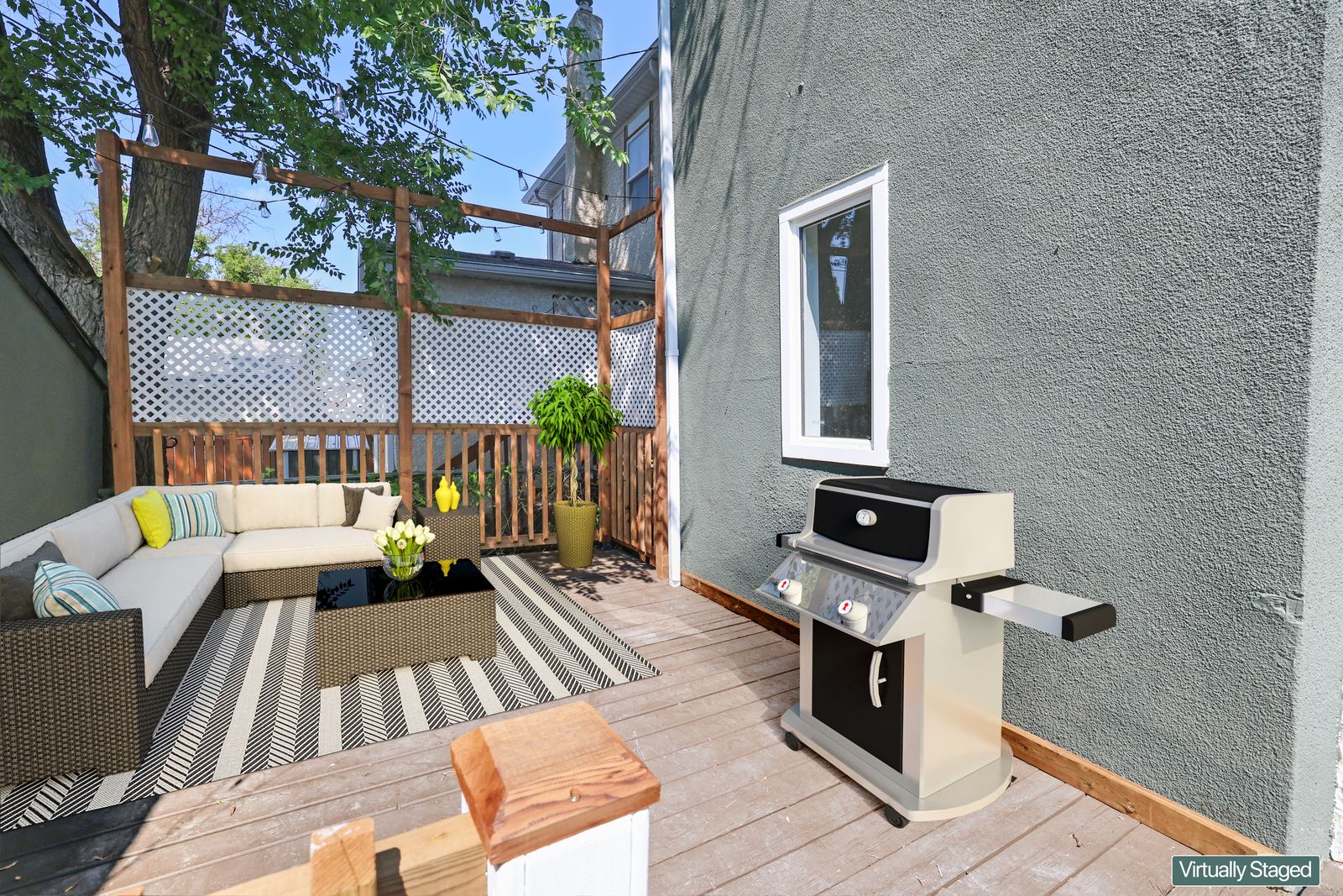 Rear deck under a cedar pergola with lattice privacy screening, virtually staged